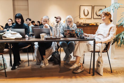 A Group of Young Women Sitting at the Table and Using Laptops