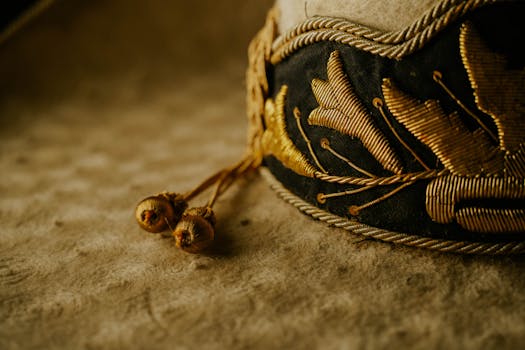 A close up of a gold and black hat