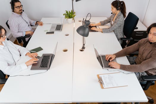 People Sitting at the Table Using Laptop