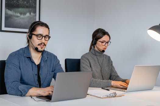 Photo of a Man and a Woman Working on Their Laptops