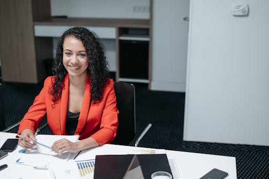 Smiling Woman in Red Blazer Sitting on Chair