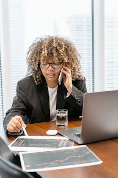 Woman in Black Blazer Sitting at the Table