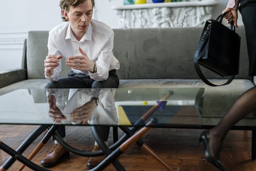 Woman in White Blazer Sitting on Chair