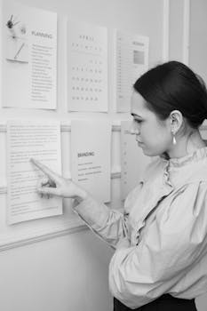 Woman in White Coat Writing on White Paper